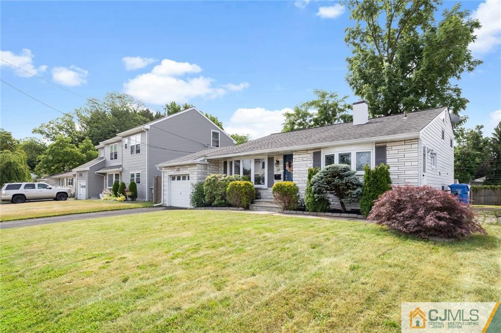 65 Albemarle Road Colonia, NJ 07067 - Photo 3 of 28 a front view of house with yard and green space