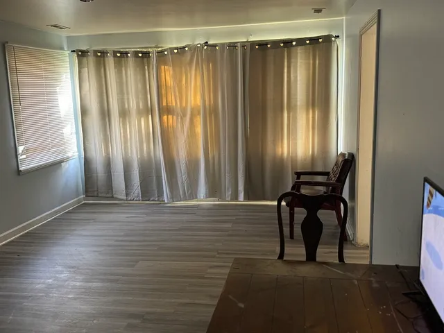 a view of a room with wooden floor and chair