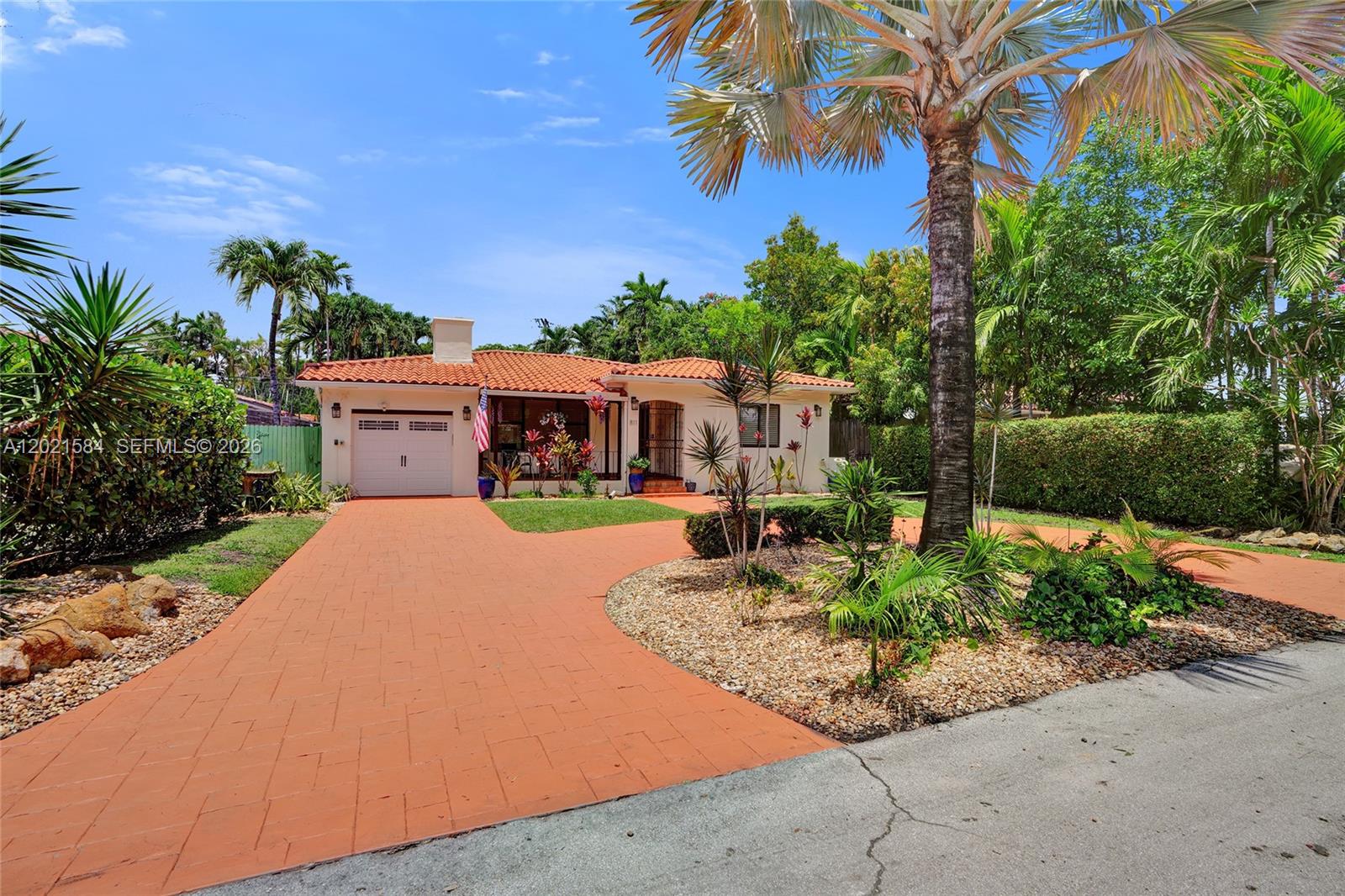 811 Northeast 73rd Street Miami, FL 33138 - Photo 1 of 51 a front view of a house with a yard and potted plants