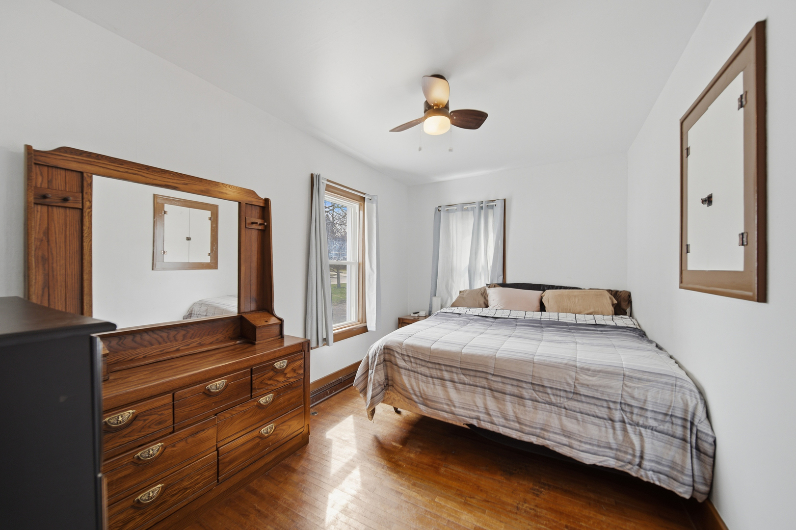 318 Spruce Street Dixon, IL 61021 - Photo 10 of 25 a bedroom with a bed and wooden floor
