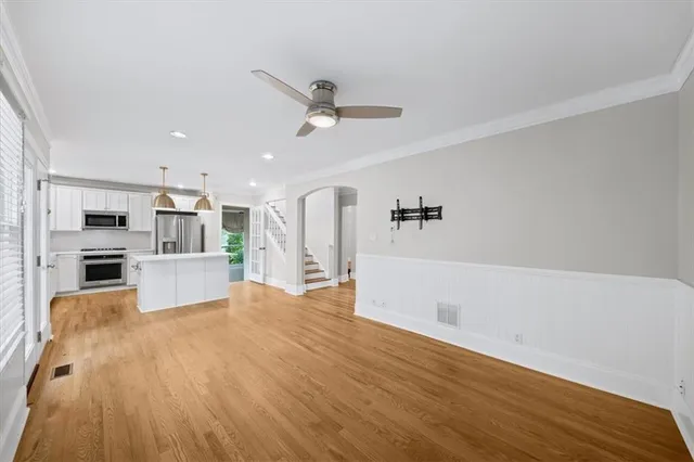 a kitchen with stainless steel appliances a sink stove and cabinets