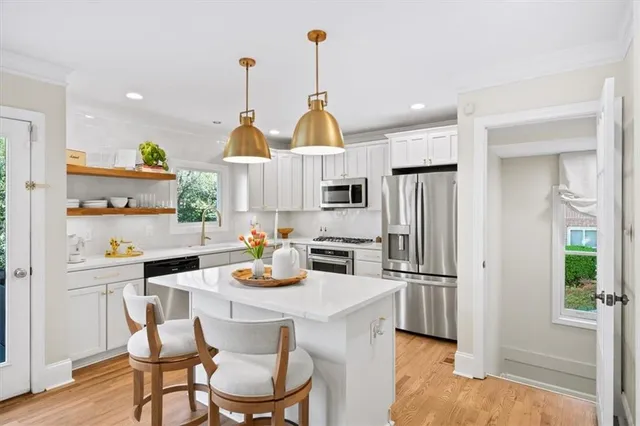 a kitchen with a refrigerator sink and stove