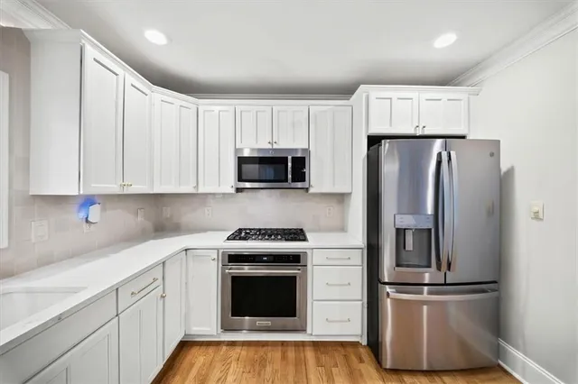a view of an empty room and wooden floor