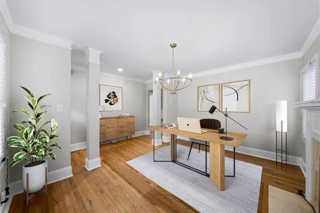 a view of a hallway with wooden floor and cabinet