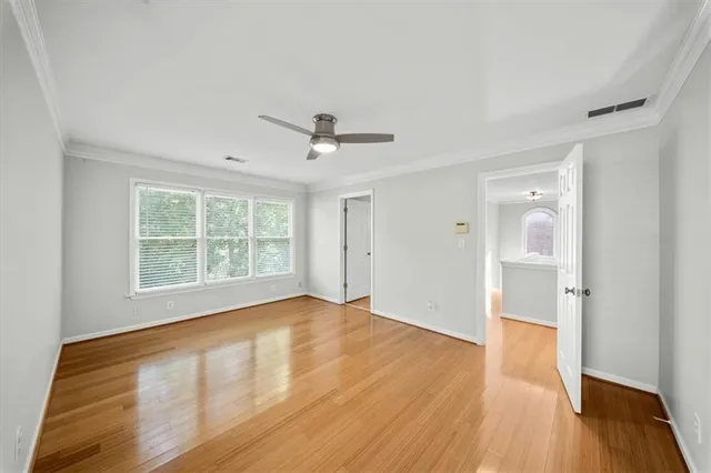 an empty room with windows and closet