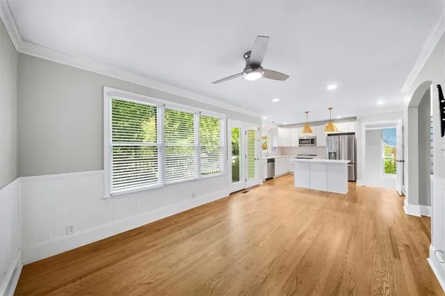 a view of a kitchen with furniture and wooden floor