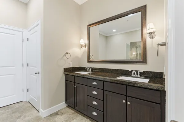 a bathroom with a granite countertop sink and a mirror