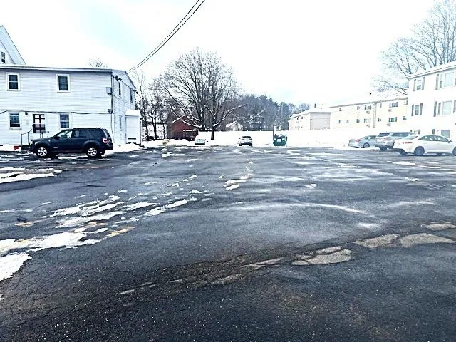 a view of a house with snow on the road