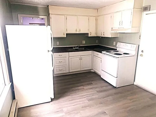 a kitchen with a refrigerator and a stove