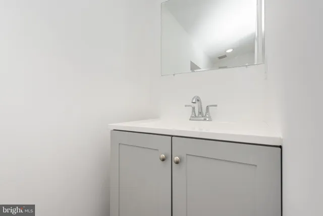 a bathroom with a sink a mirror and vanity