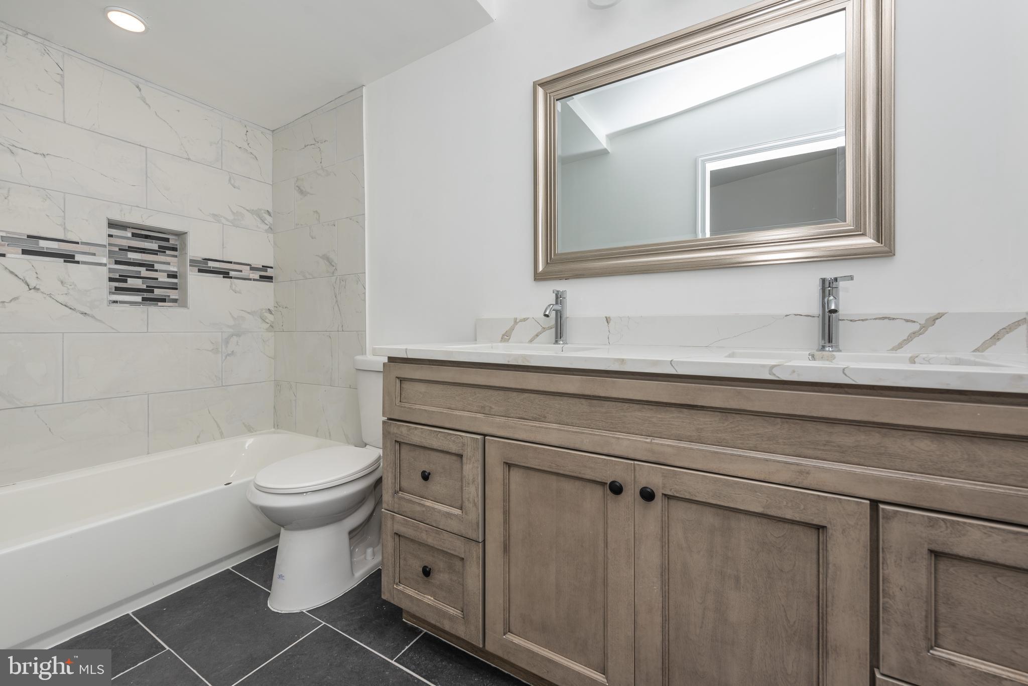1007 North Mount Street Baltimore, MD 21217 - Photo 18 of 22 a bathroom with a sink toilet and shower