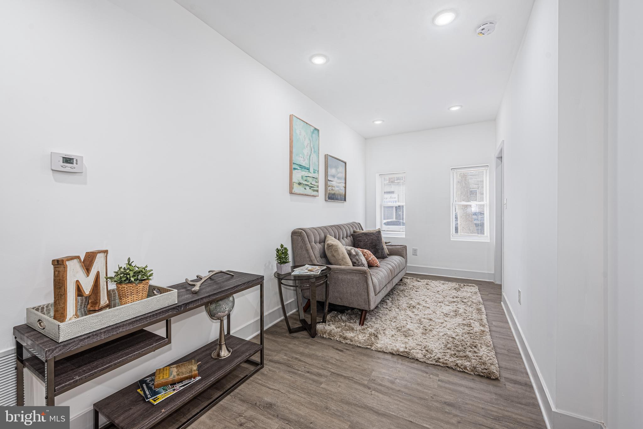 1007 North Mount Street Baltimore, MD 21217 - Photo 3 of 22 a living room with furniture and wooden floor