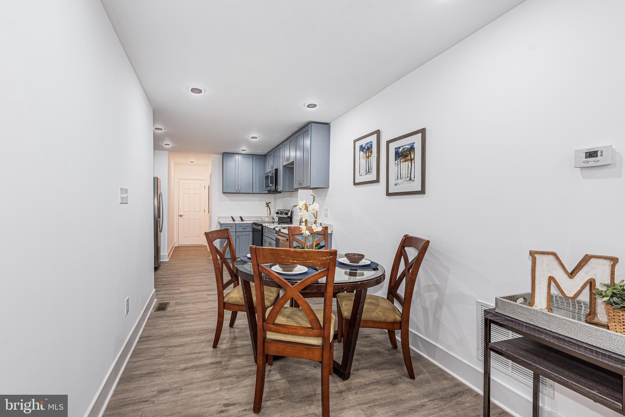 1007 North Mount Street Baltimore, MD 21217 - Photo 4 of 22 a view of a dining room with furniture and wooden floor