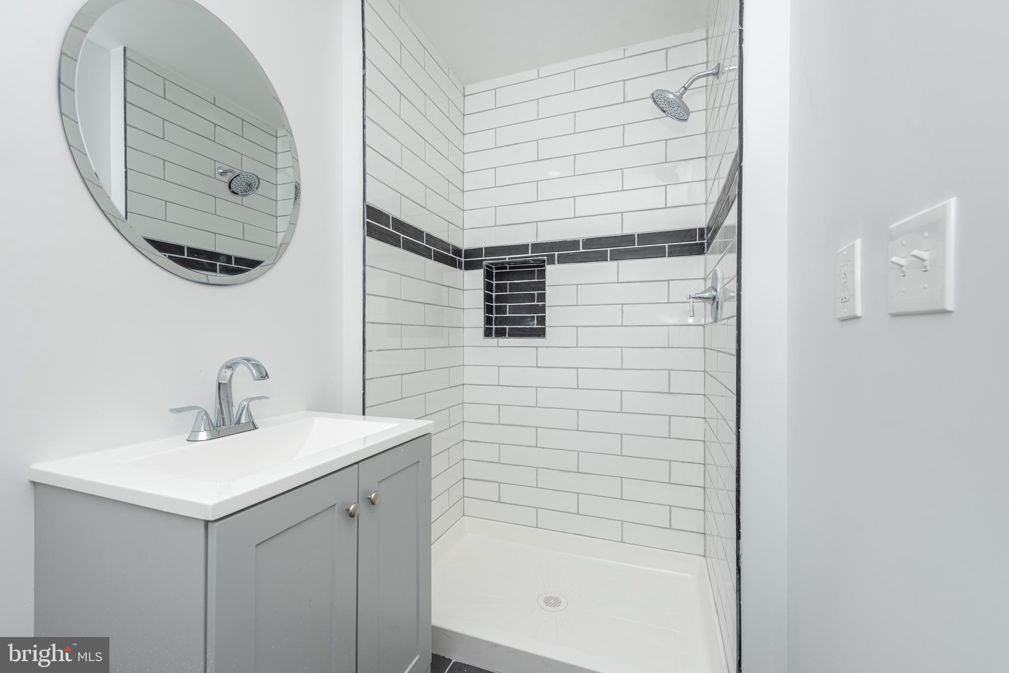 1007 North Mount Street Baltimore, MD 21217 - Photo 8 of 22 a bathroom with a sink and a mirror