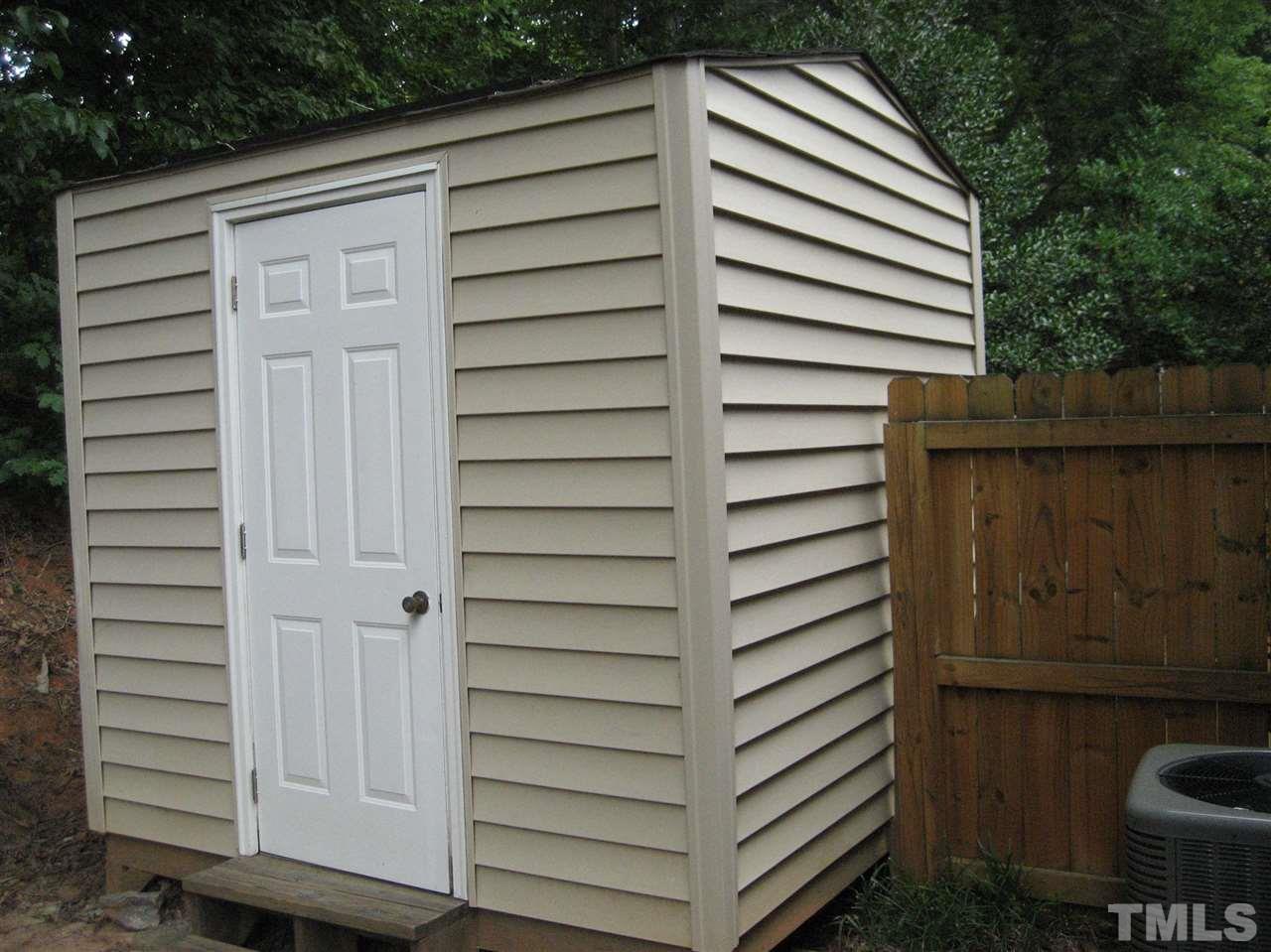 7737 Ohmann Court Raleigh, NC 27615 - Photo 19 of 19 a view of a wooden door and outdoor space