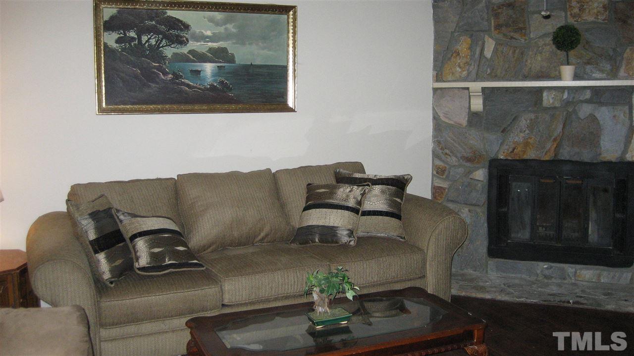 7737 Ohmann Court Raleigh, NC 27615 - Photo 3 of 19 a living room with furniture and a fireplace