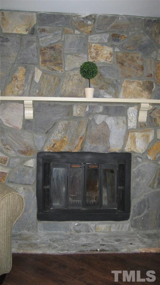 7737 Ohmann Court Raleigh, NC 27615 - Photo 4 of 19 a wooden floor with a stove