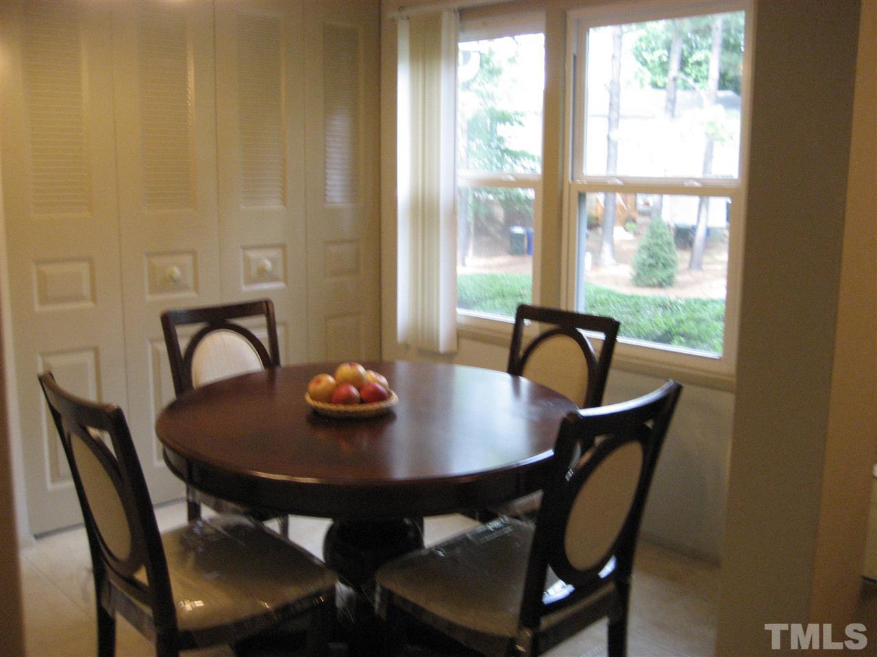 7737 Ohmann Court Raleigh, NC 27615 - Photo 5 of 19 a view of a table and chairs in a patio