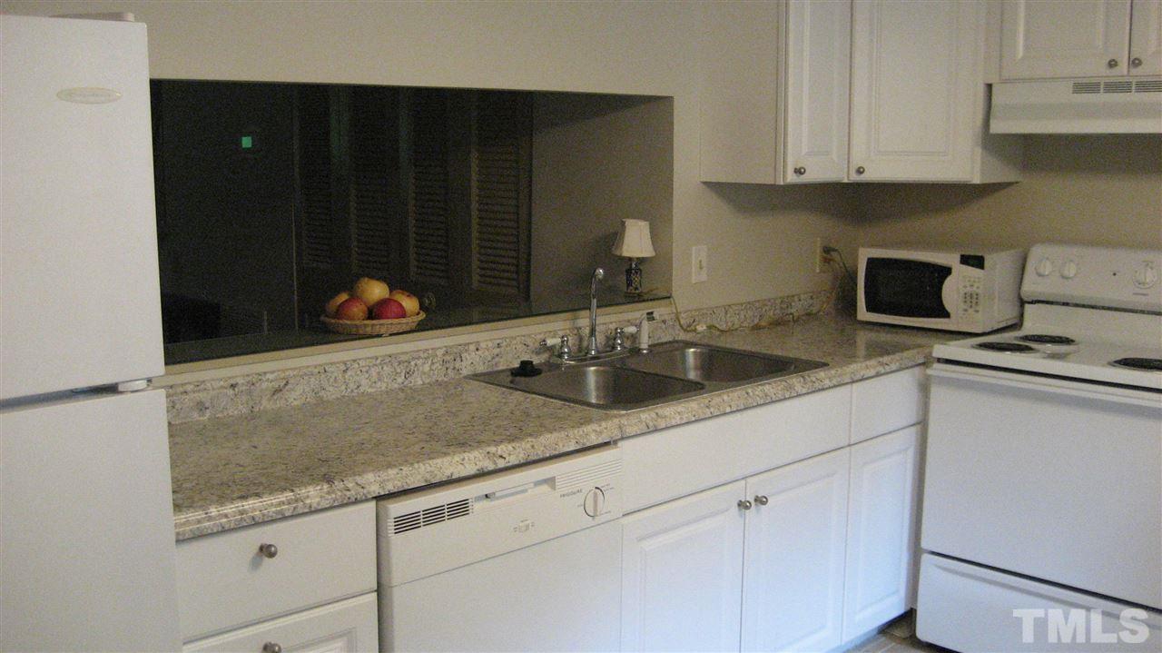 7737 Ohmann Court Raleigh, NC 27615 - Photo 8 of 19 a kitchen with stainless steel appliances granite countertop a sink stove and cabinets