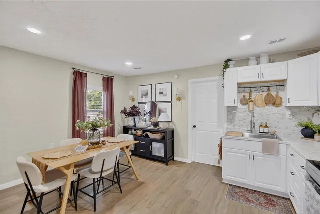 a kitchen with stainless steel appliances a refrigerator and wooden floor