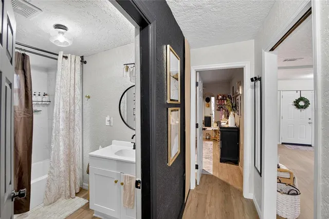 a bathroom with a sink a mirror a toilet and a shower