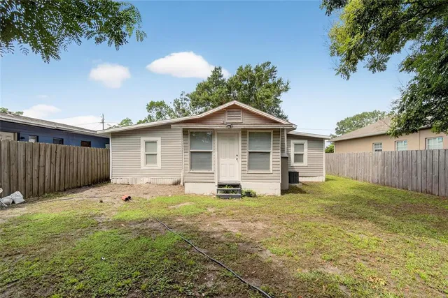 a backyard of a house with yard and trampoline