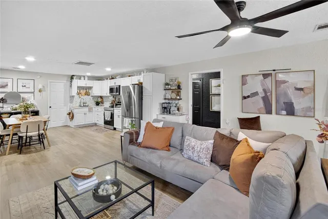 a living room with furniture and kitchen view