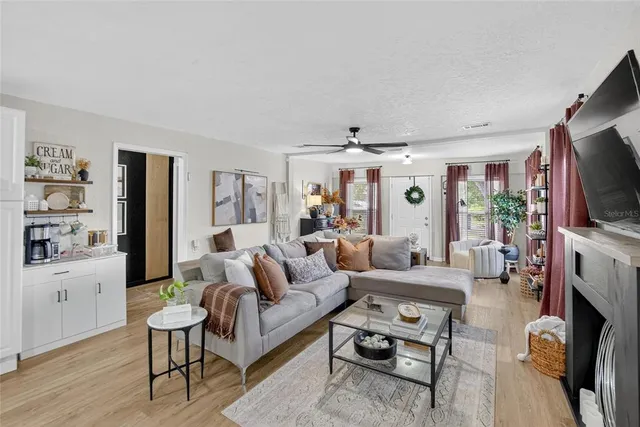 a living room with furniture a flat screen tv and a fireplace