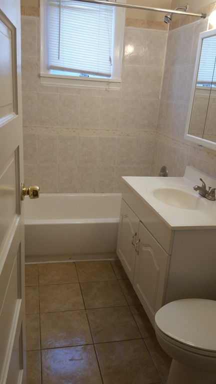35 Kenberma Road Boston, MA 02124 - Photo 11 of 17 a bathroom with a sink a toilet and shower