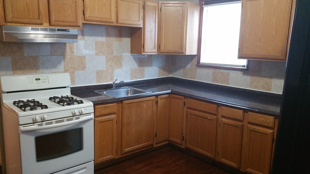 35 Kenberma Road Boston, MA 02124 - Photo 12 of 17 a kitchen with granite countertop a stove and a sink