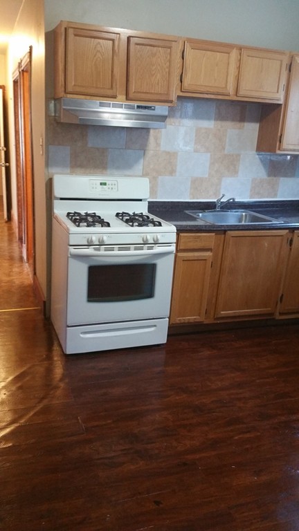 35 Kenberma Road Boston, MA 02124 - Photo 13 of 17 a stove top oven sitting inside of a kitchen