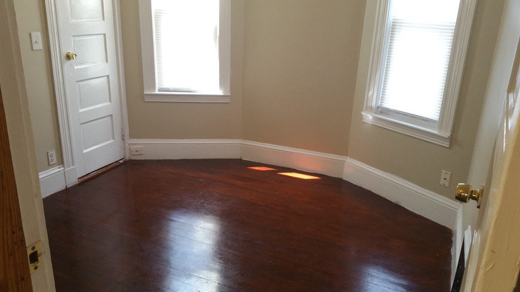35 Kenberma Road Boston, MA 02124 - Photo 7 of 17 an empty room with wooden floor and windows