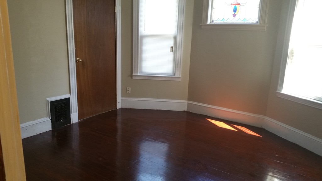 35 Kenberma Road Boston, MA 02124 - Photo 10 of 17 an empty room with wooden floor and windows