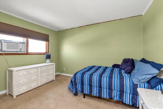 a bedroom with a bed and a dresser