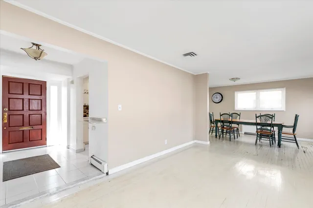 a dining room with furniture and window