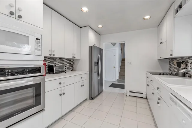 a kitchen with cabinets appliances and a counter space