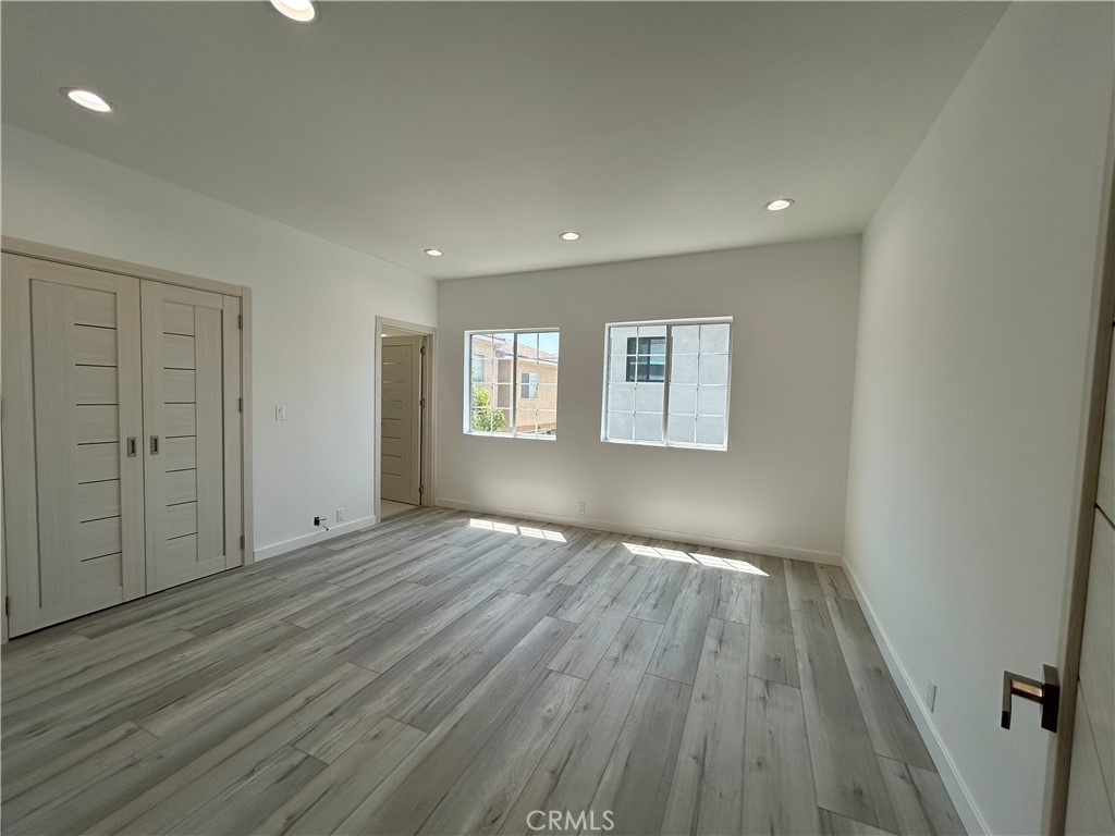 10363 Commerce Avenue Tujunga, CA 91042 - Photo 16 of 31 wooden floor in an empty room with a window