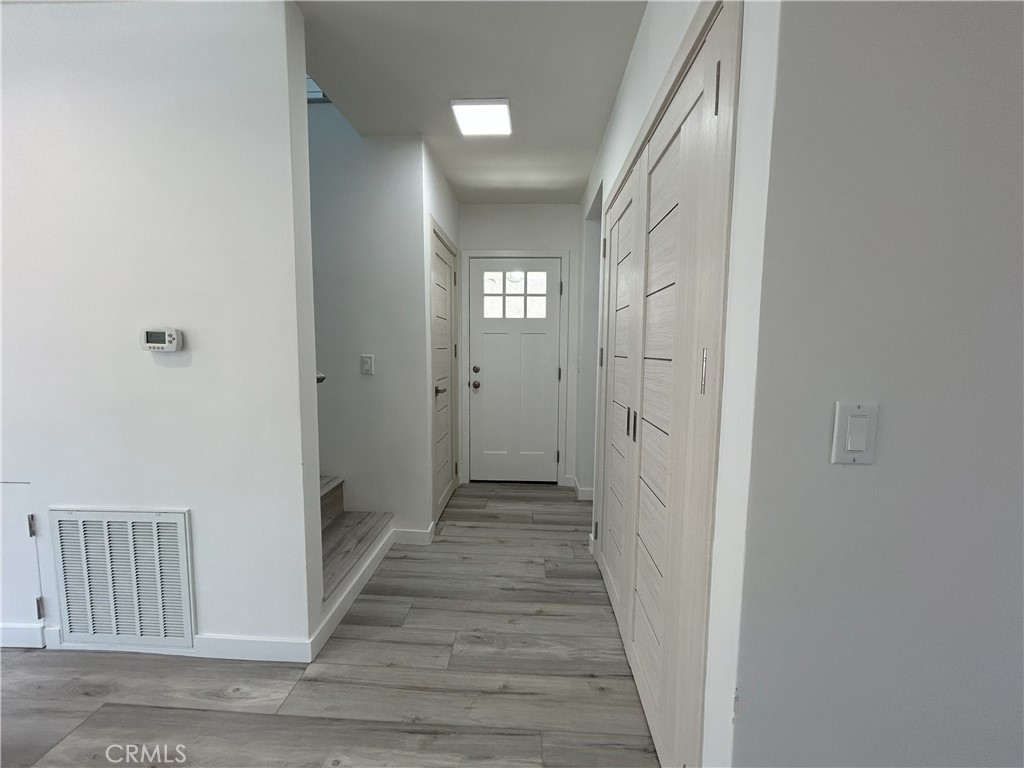 10363 Commerce Avenue Tujunga, CA 91042 - Photo 21 of 31 a view of a hallway with wooden floor and a hallway