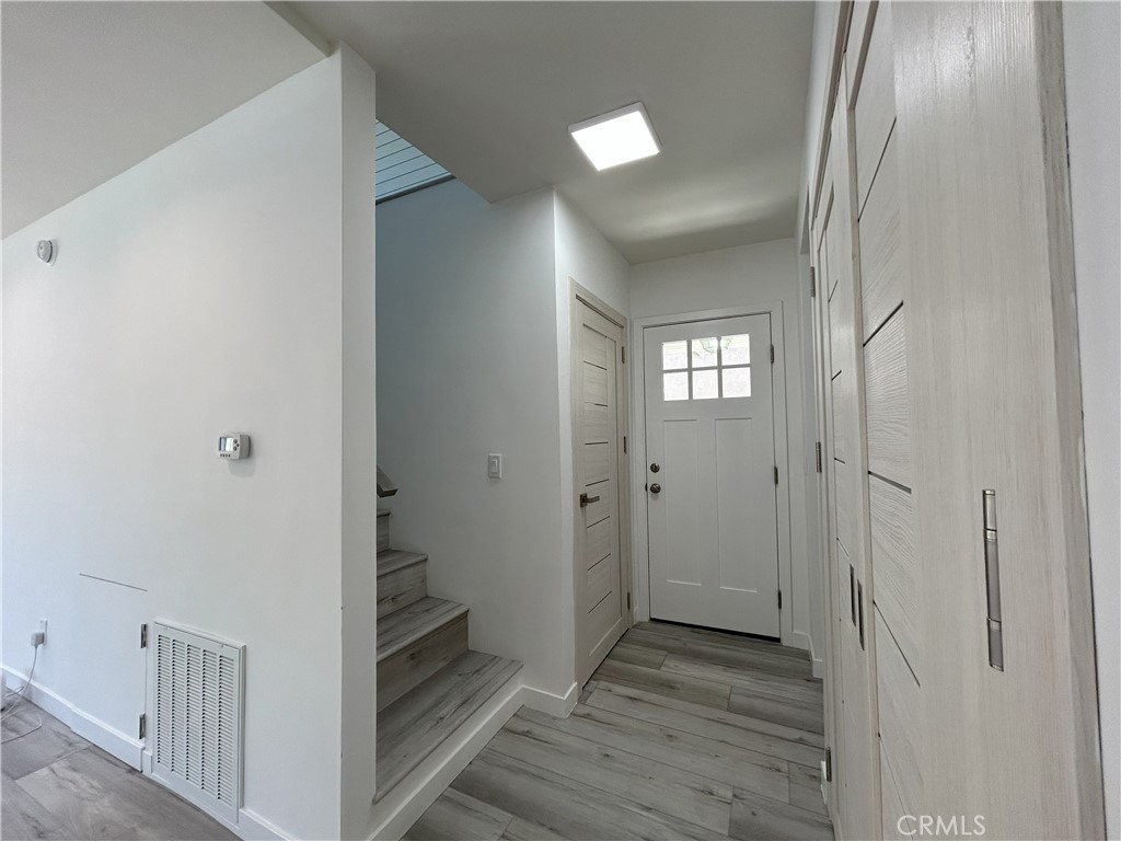 10363 Commerce Avenue Tujunga, CA 91042 - Photo 22 of 31 a view of a hallway with wooden floor and closet