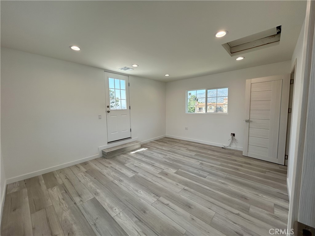 10363 Commerce Avenue Tujunga, CA 91042 - Photo 8 of 31 an empty room with wooden floor and windows