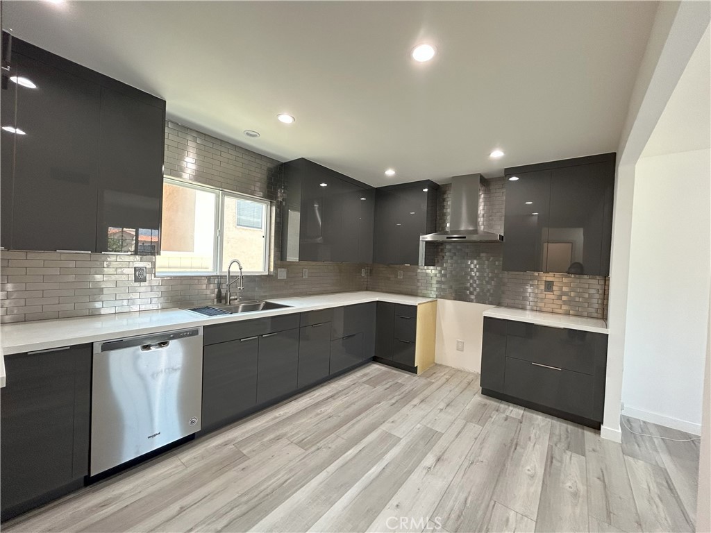 10363 Commerce Avenue Tujunga, CA 91042 - Photo 10 of 31 a large kitchen with stainless steel appliances kitchen island granite countertop a sink and cabinets