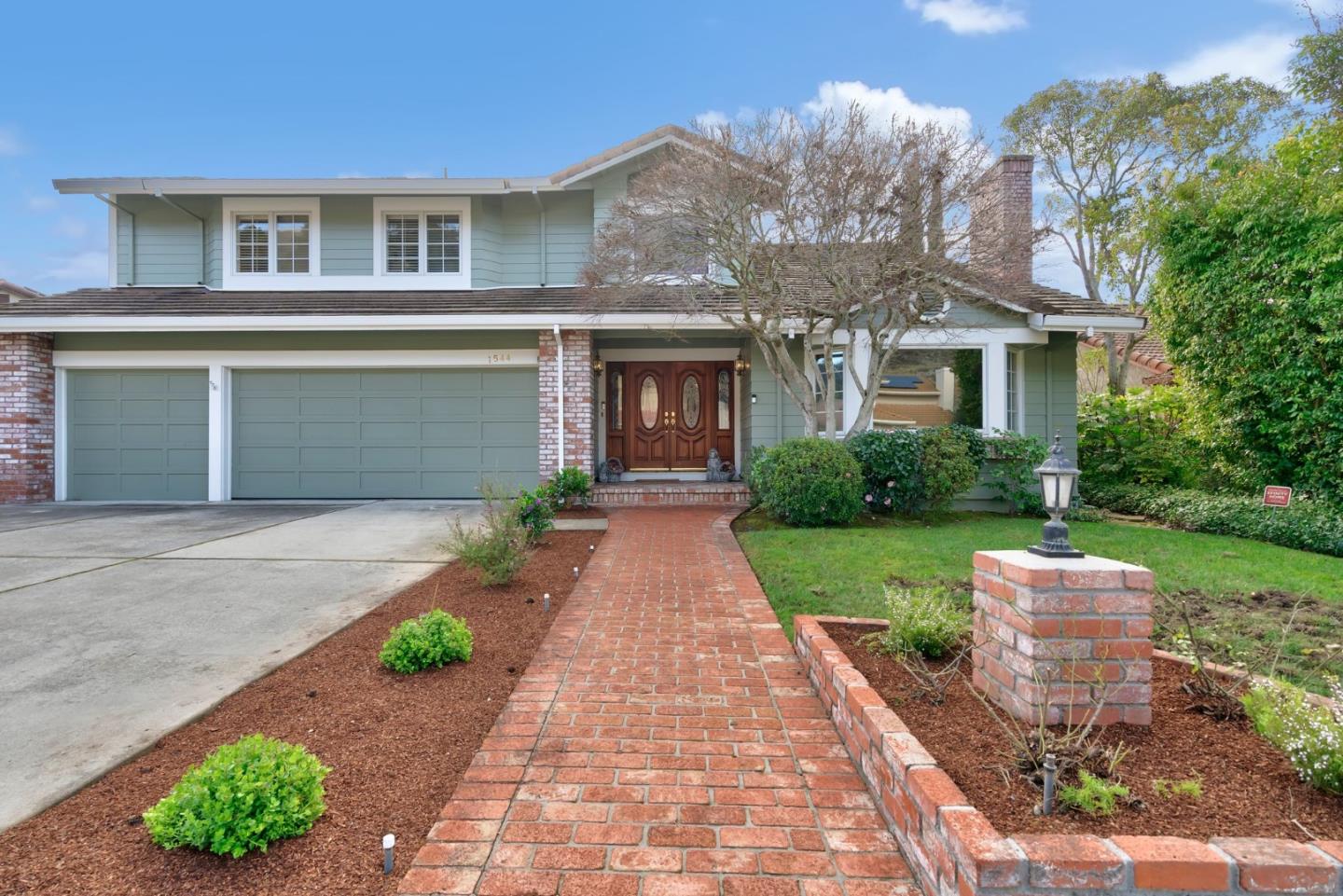 1544 Edmond Drive San Carlos, CA 94070 - Photo 2 of 44 a front view of a house with a garden and plants