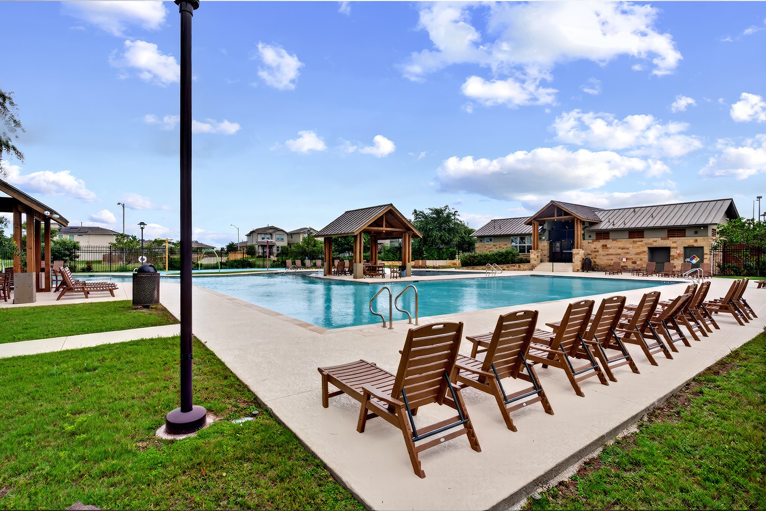 2006 Grow Lane Austin, TX 78754 - Photo 34 of 40 An inviting community pool with ample lounge seating and shaded cabanas, perfect for relaxation.