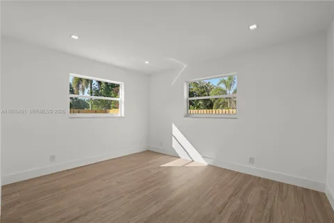 an aerial view of residential houses with outdoor space and street view