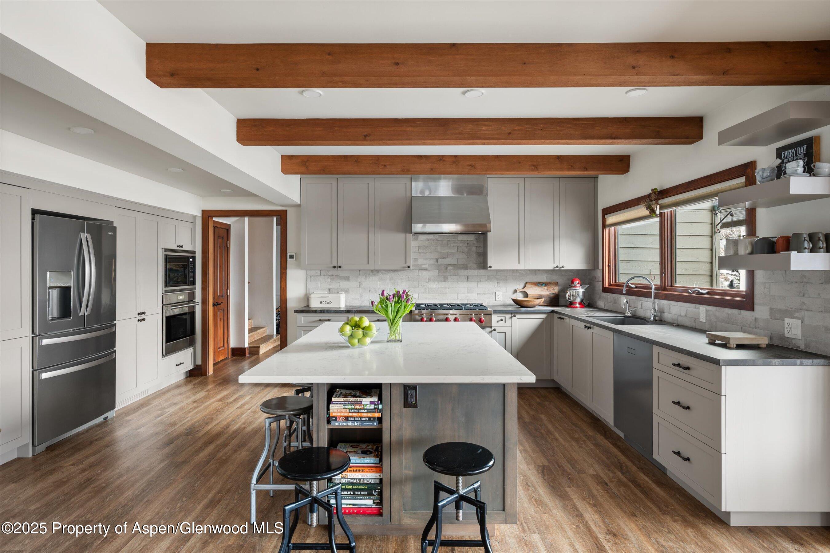 516 Sinclair Road Snowmass Village, CO 81615 - Photo 13 of 37 a kitchen with a table chairs sink and cabinets