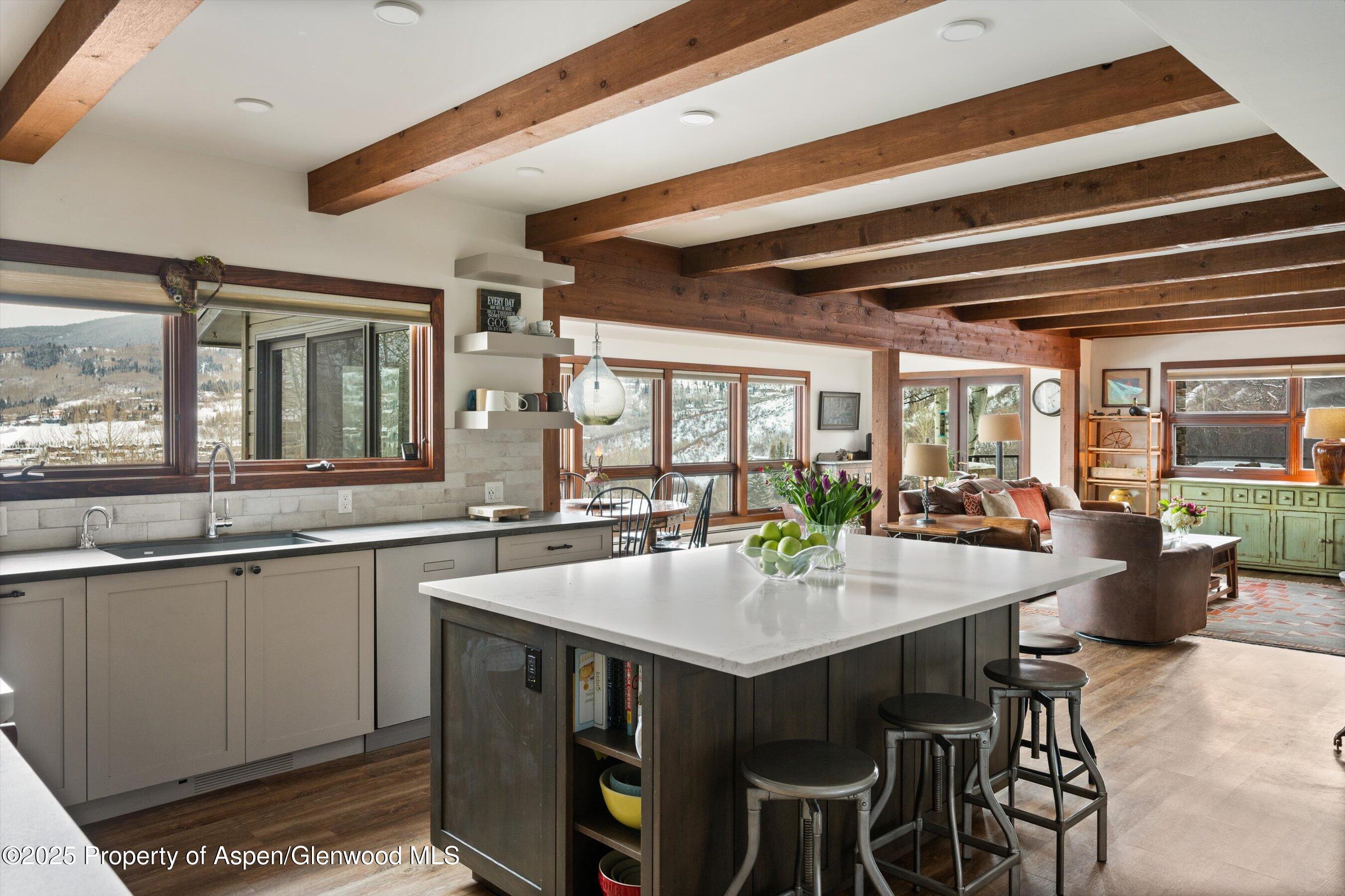 516 Sinclair Road Snowmass Village, CO 81615 - Photo 15 of 37 a kitchen with a sink and wooden cabinets