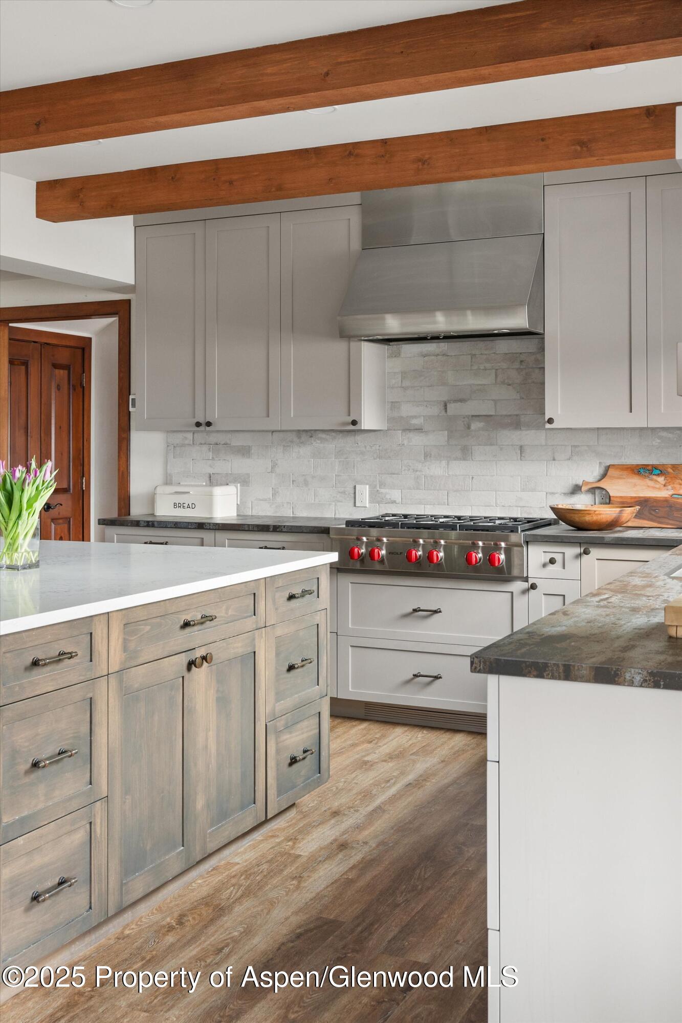 516 Sinclair Road Snowmass Village, CO 81615 - Photo 16 of 37 a kitchen with granite countertop a sink and cabinets