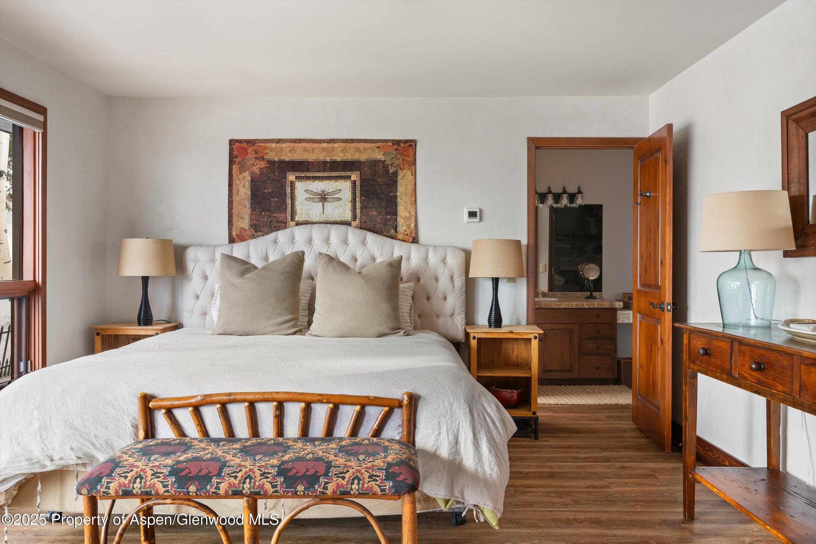 516 Sinclair Road Snowmass Village, CO 81615 - Photo 29 of 37 a bedroom with a bed and wooden floor
