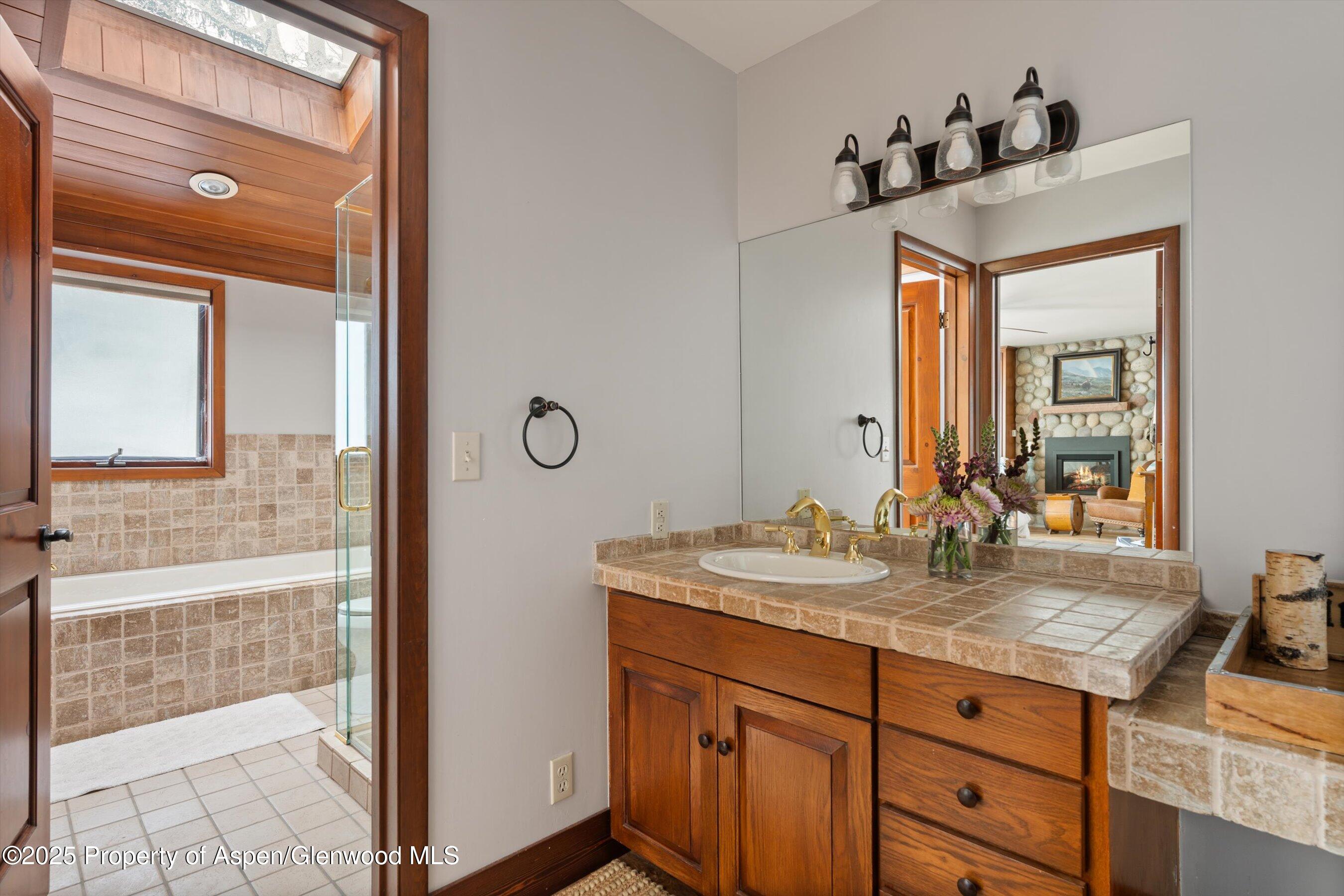 516 Sinclair Road Snowmass Village, CO 81615 - Photo 30 of 37 a bathroom with a granite countertop sink and a mirror