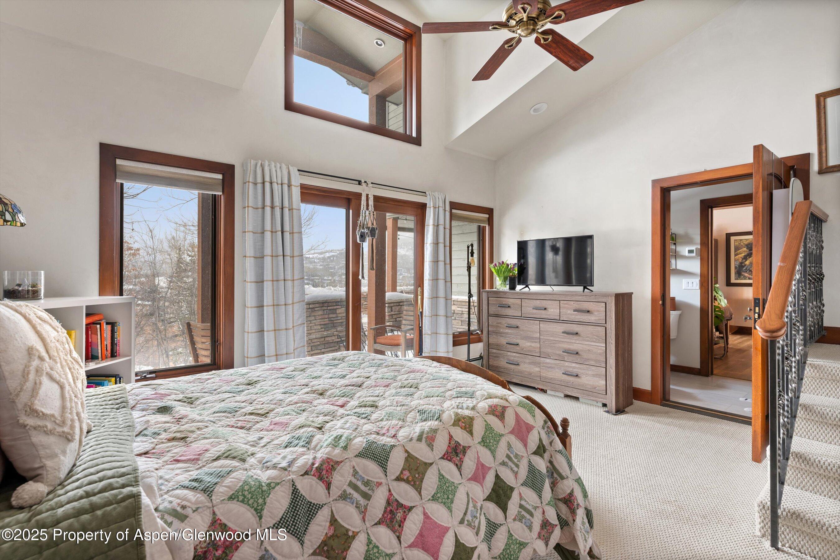 516 Sinclair Road Snowmass Village, CO 81615 - Photo 31 of 37 a bedroom with a bed dresser and a flat tv screen